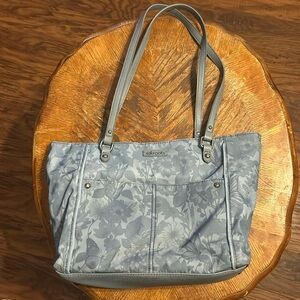 Denim blue Sakroots shoulder bag.  Printed with butterflies and flowers